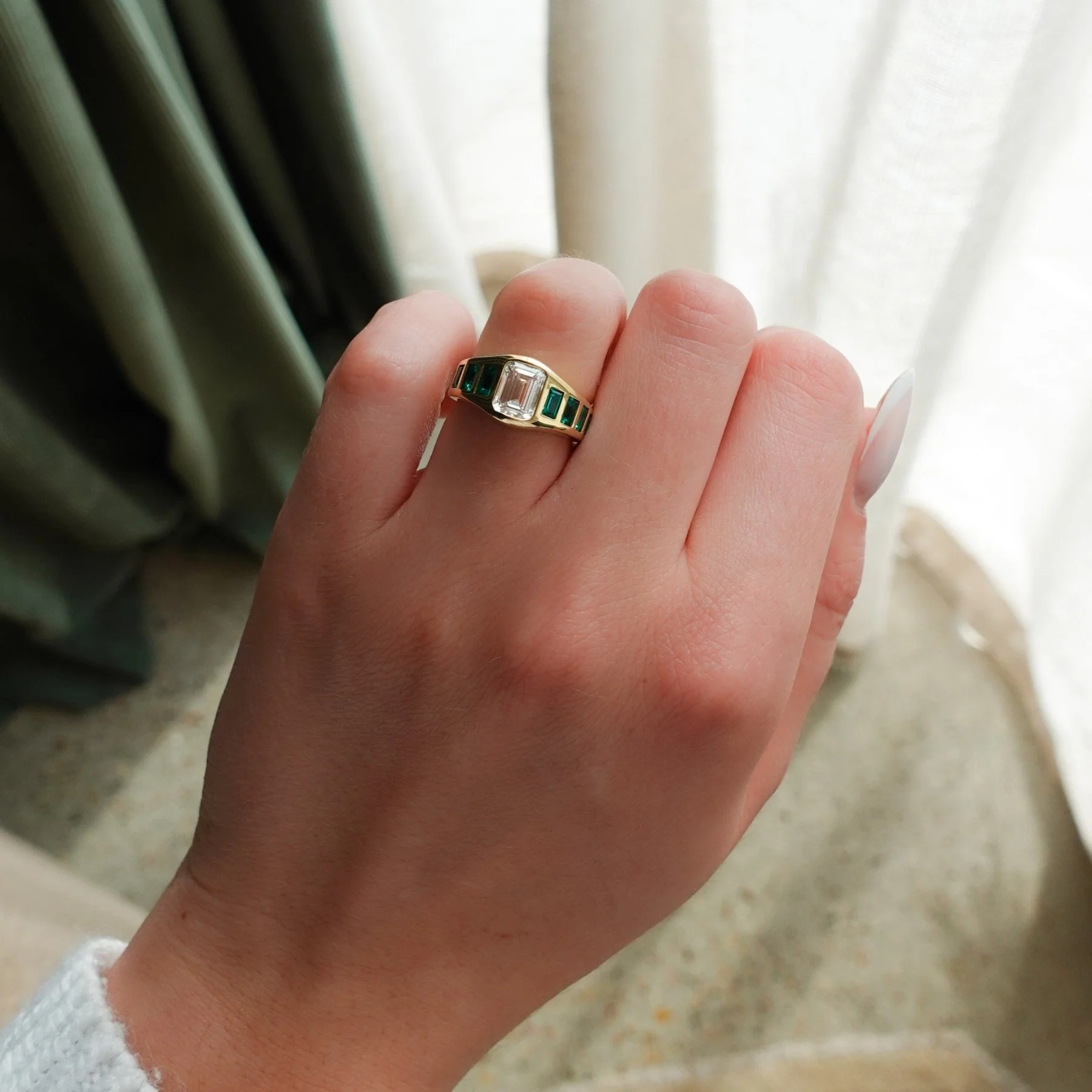 Brick Road Engagement Ring with Green Emeralds and an Emerald Cut - Image 3