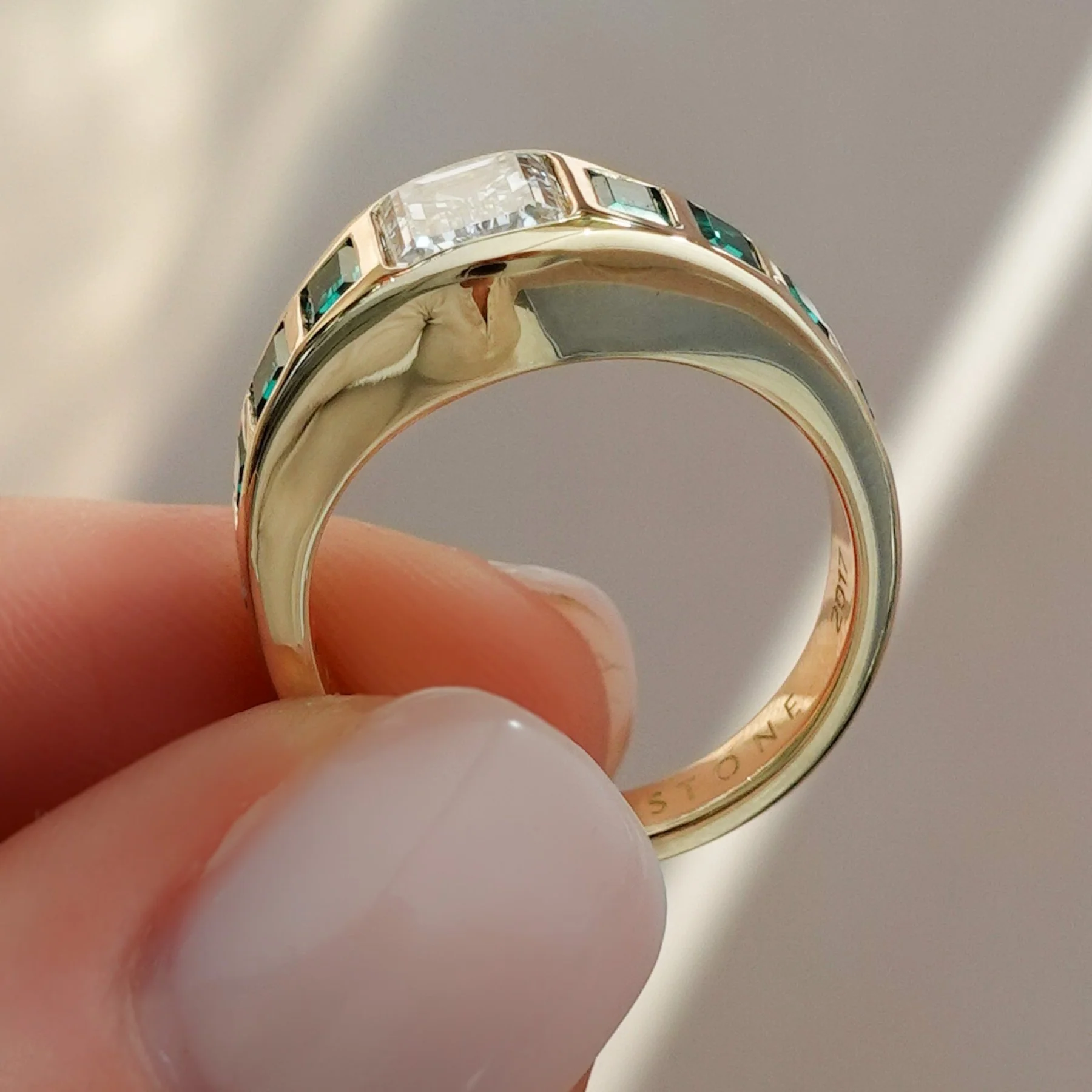 Brick Road Engagement Ring with Green Emeralds and an Emerald Cut - Image 4
