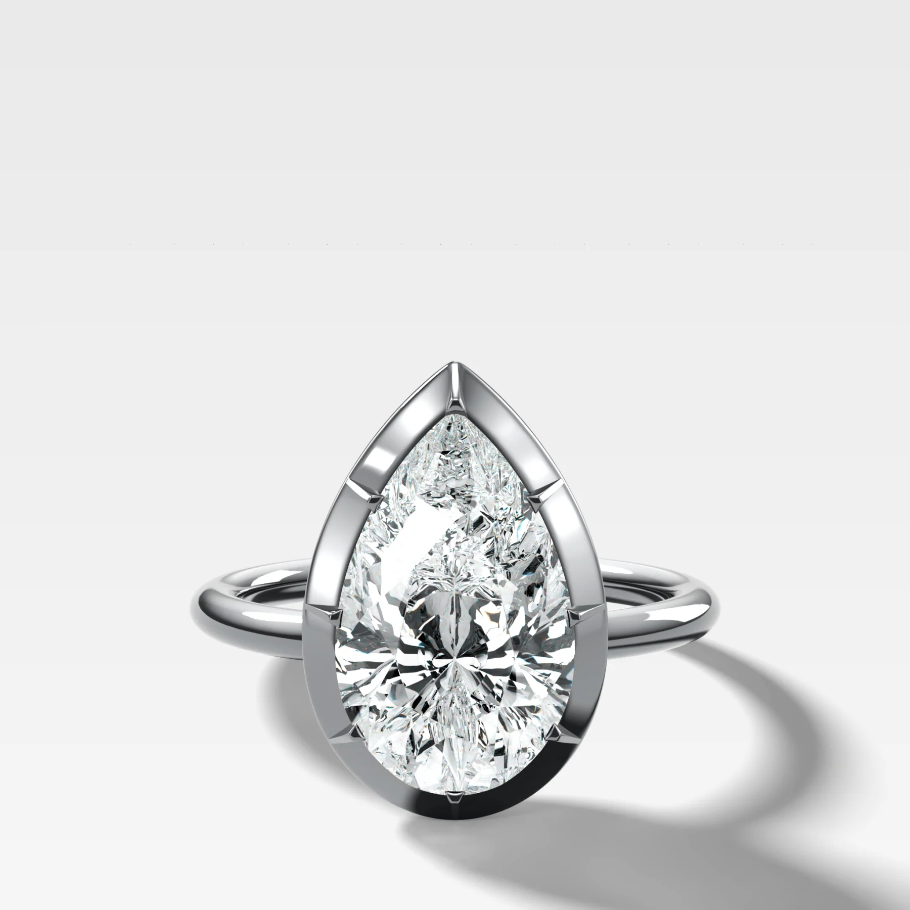 Button Back Solitaire Engagement Ring With a Pear Cut Diamond - Image 3
