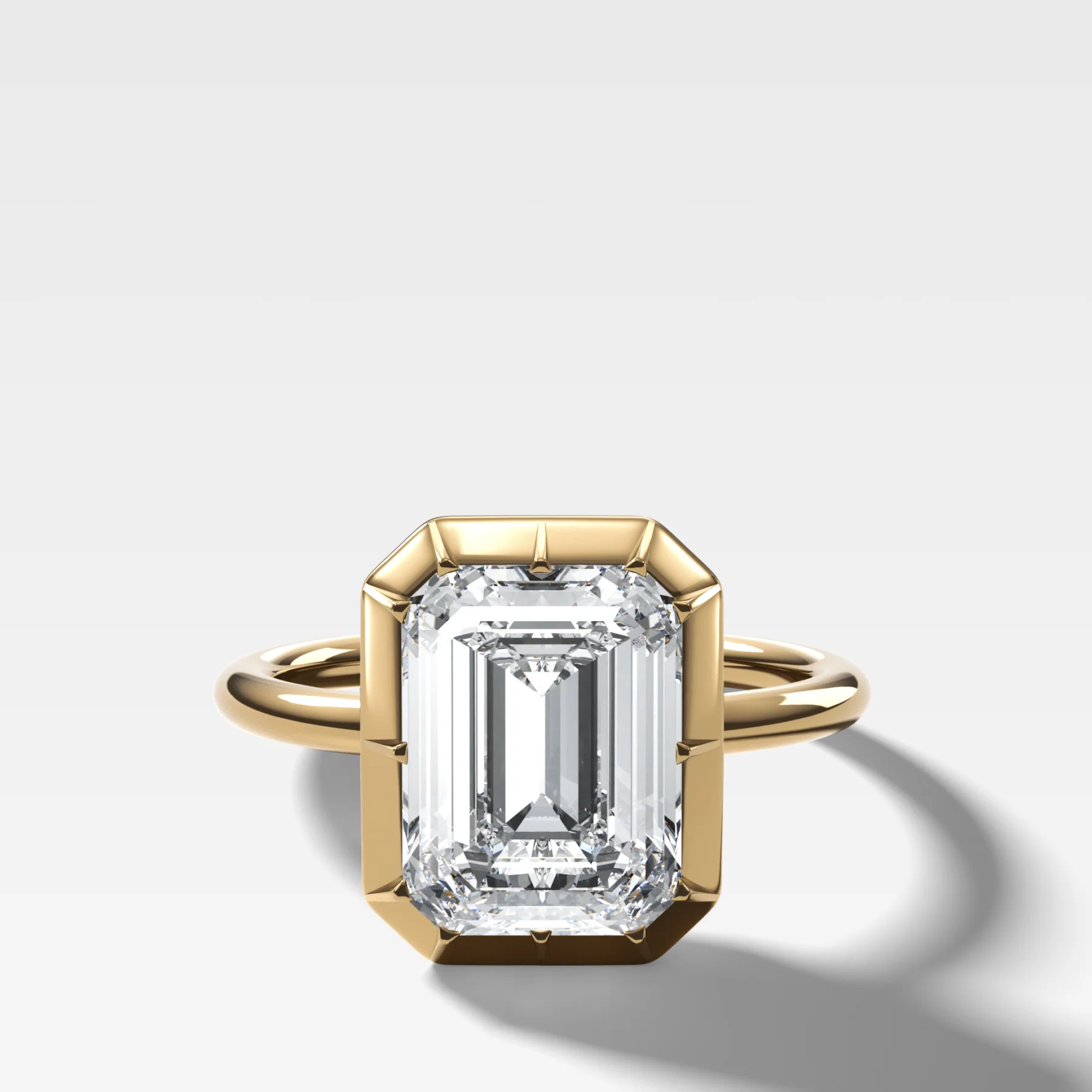 Button Back Solitaire Engagement Ring With an Emerald Cut Diamond