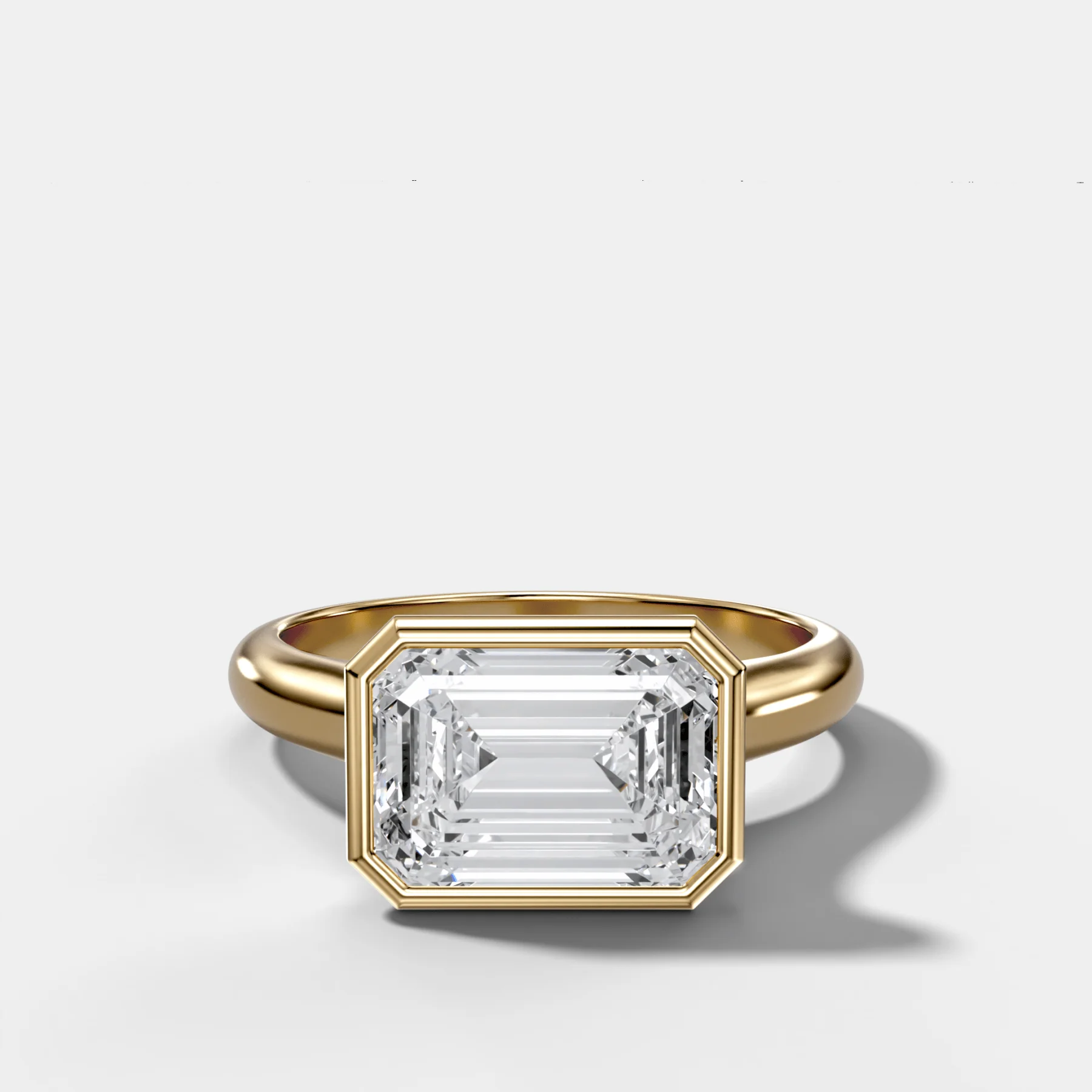 Cathedral Bezel Set Solitaire Engagement Ring With Emerald Cut Diamond (East West)
