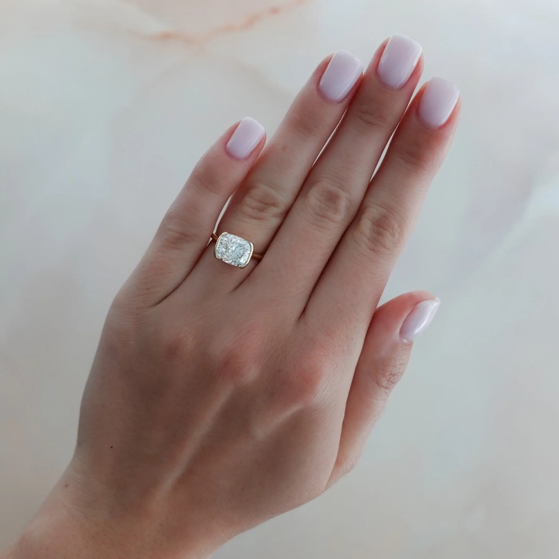 East West Half Bezel Solitaire Engagement Ring With Elongated Cushion Cut Diamond - Image 3