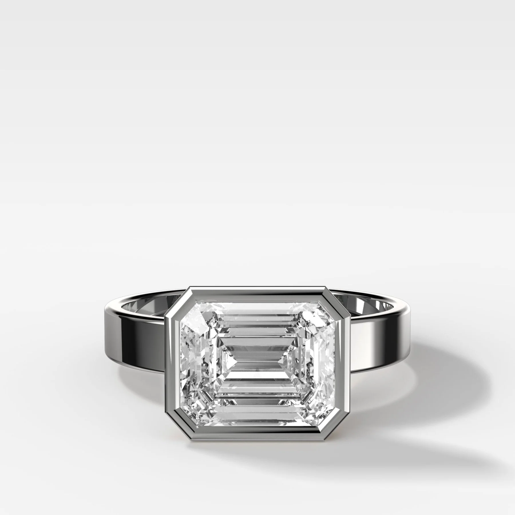 Finest Bezel Set Engagement Ring With East West Emerald Cut Diamond - Image 3