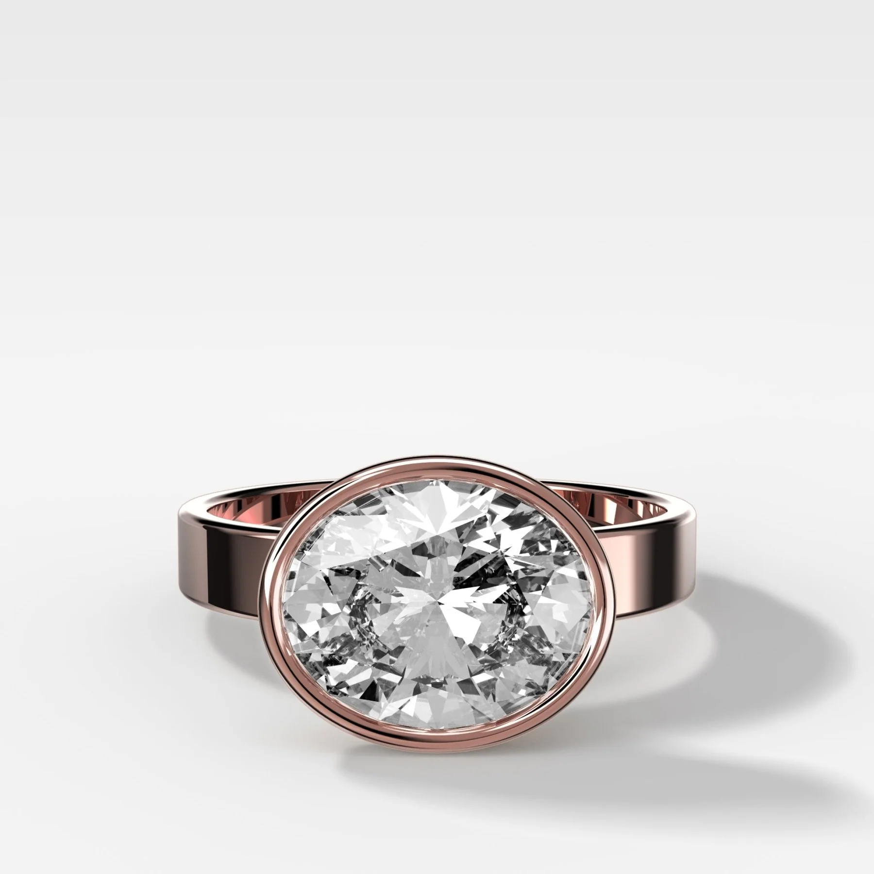 Finest Bezel Set Engagement Ring With East West Oval Cut Diamond - Image 4