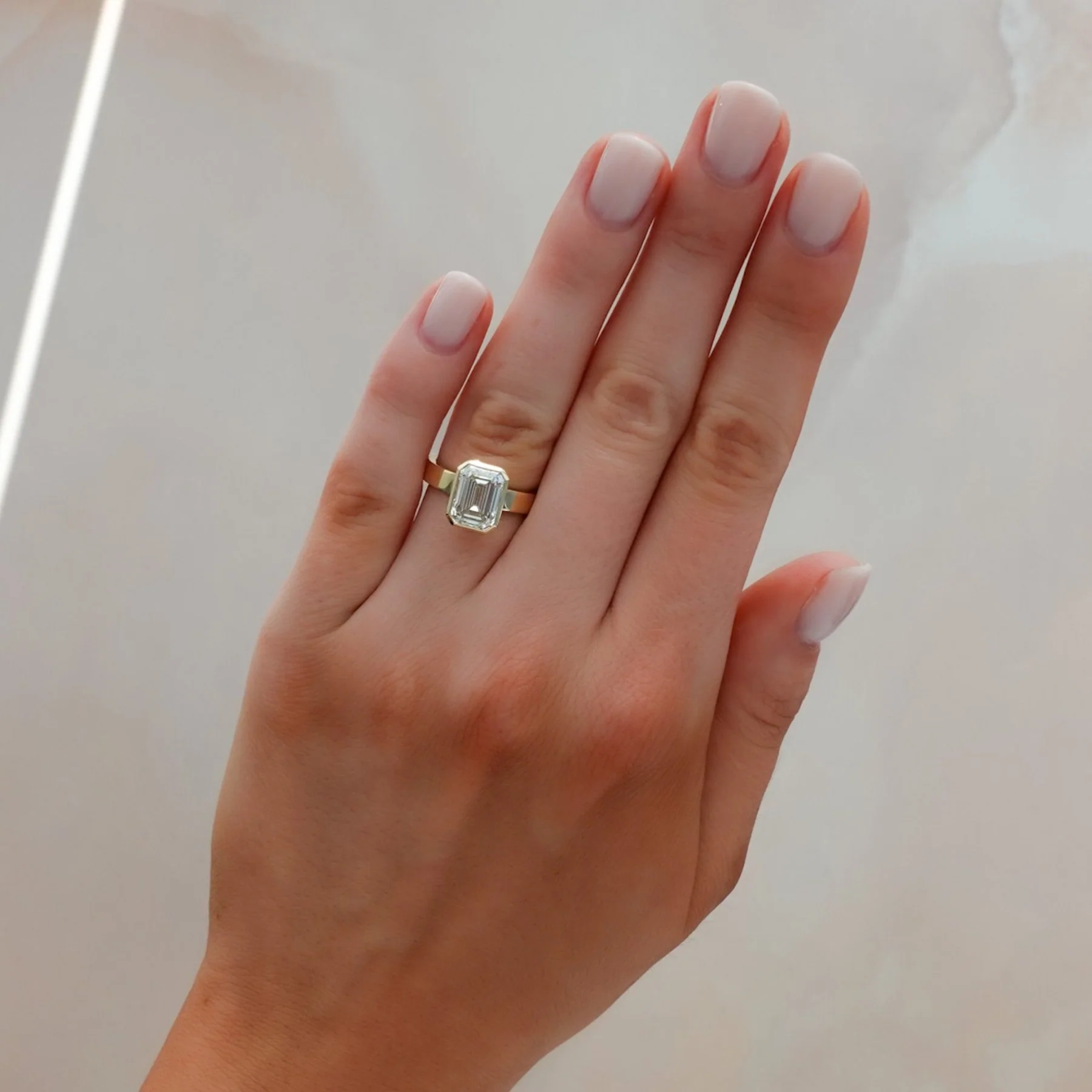 Finest Bezel Set Engagement Ring With Emerald Cut Diamond - Image 3