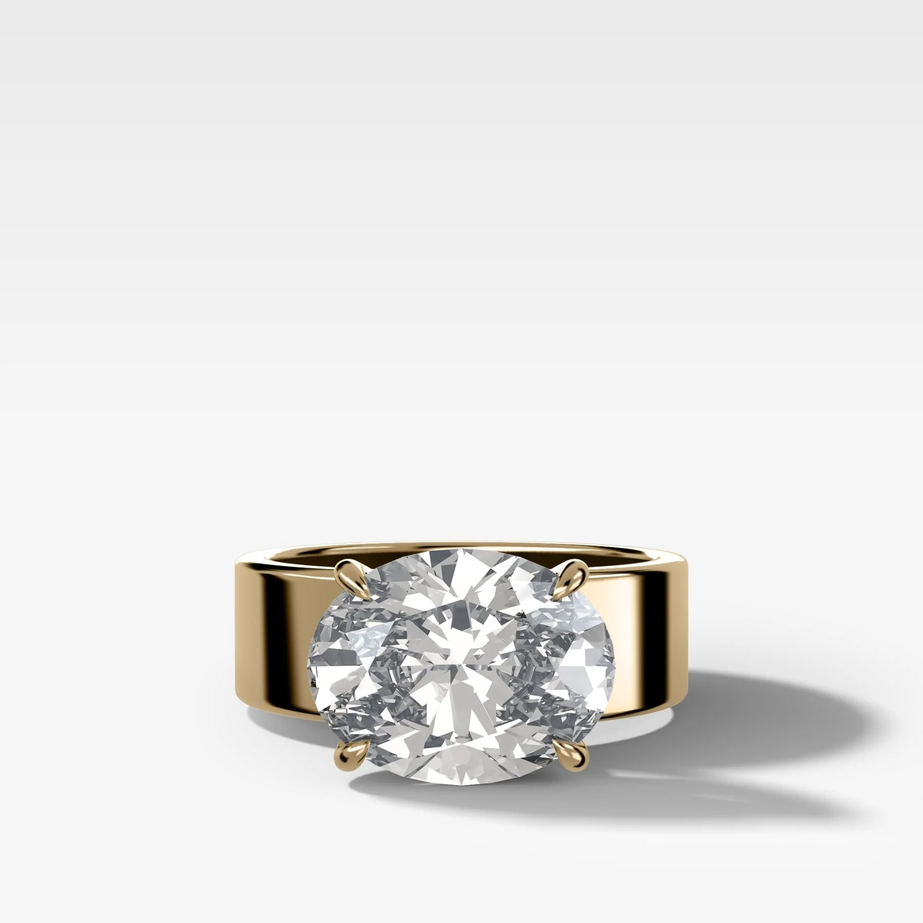 Finest Cigar Band Engagement Ring with East West Oval Cut Diamond