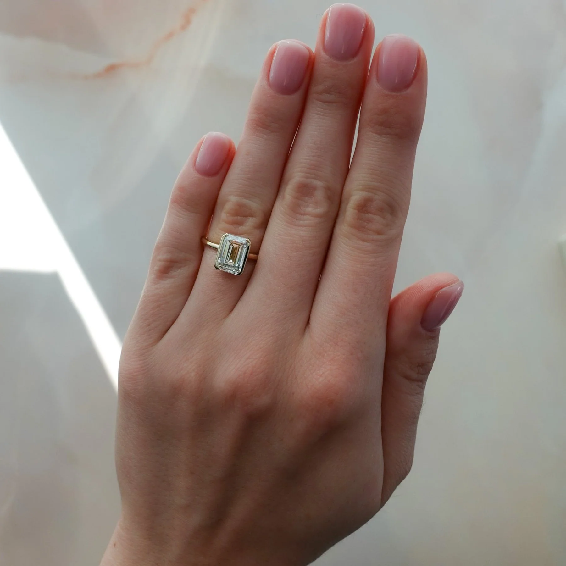 North South Half Bezel Solitaire Engagement Ring With Emerald Cut Diamond - Image 3