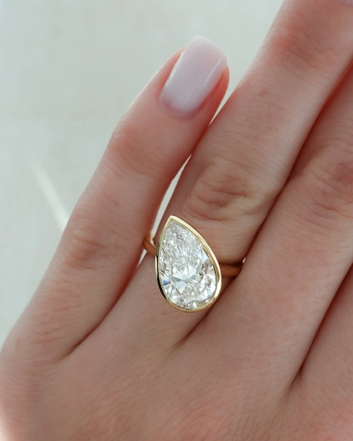 Penumbra Bezel Set Engagement Ring With Tilted Pear Cut - Image 3