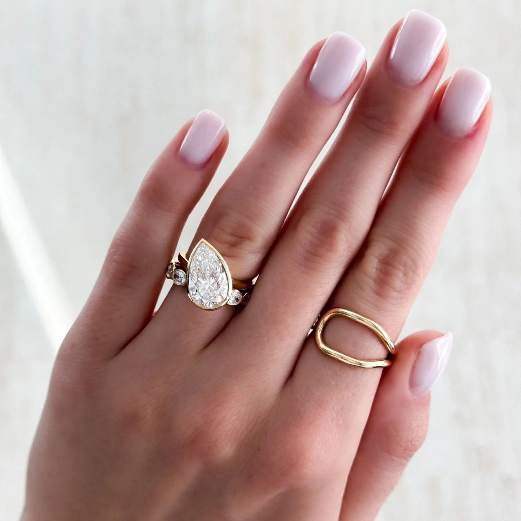 Penumbra Bezel Set Engagement Ring With Tilted Pear Cut - Image 9