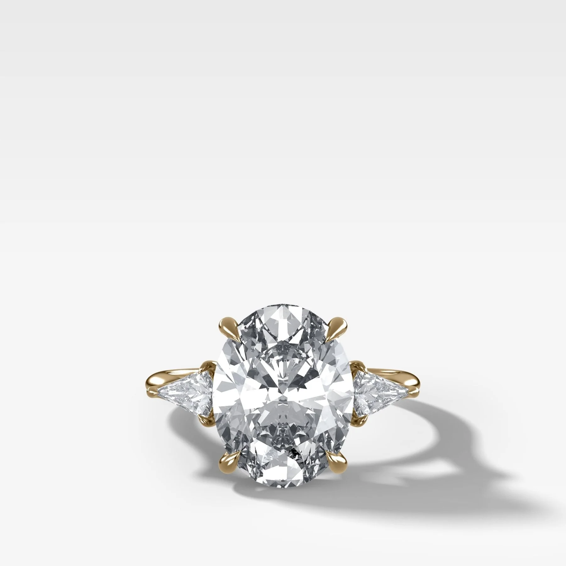 Three Stone Engagement Ring With Kite Side Stones and Oval Cut Diamond