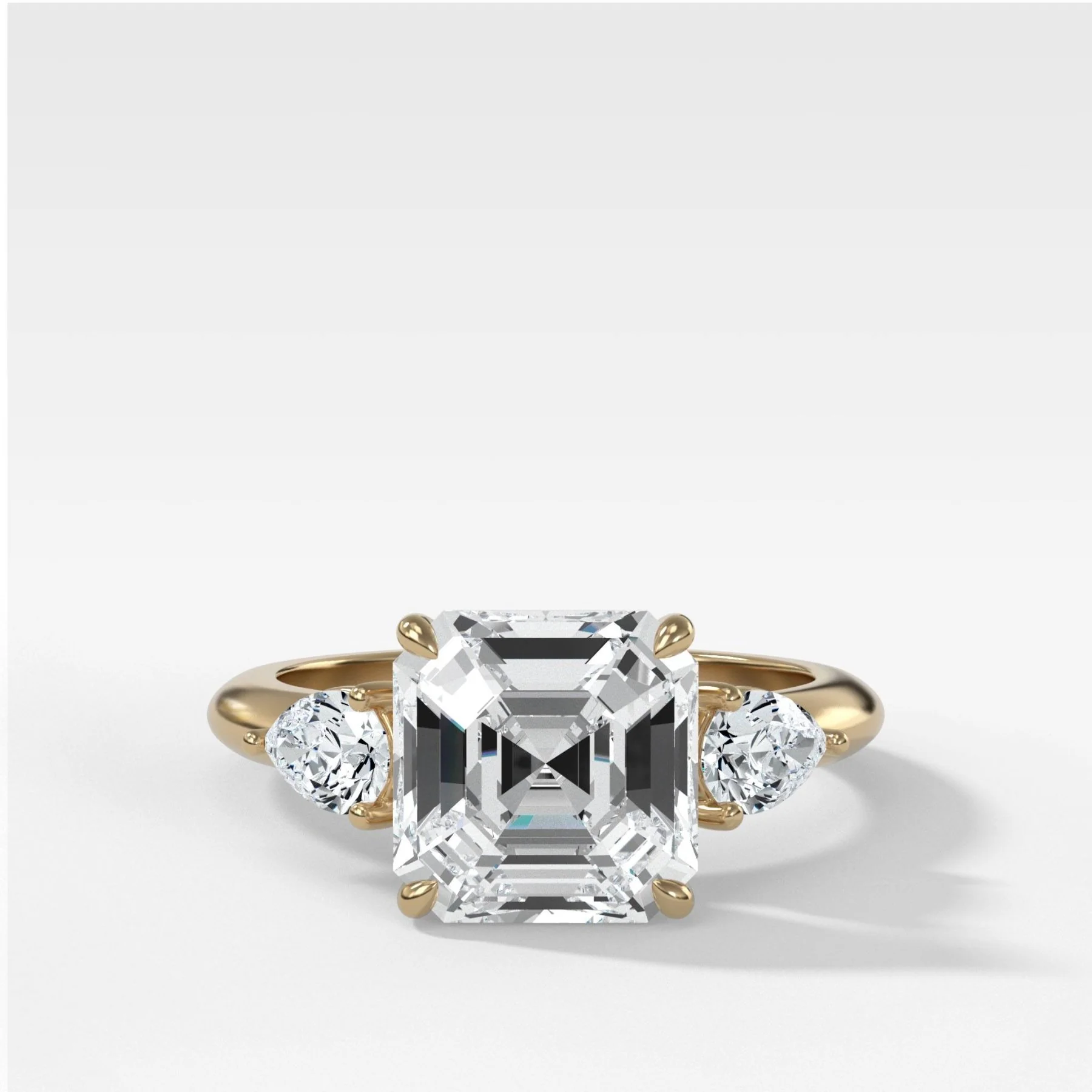 Three Stone Engagement Ring With Pear Side Stones and Asscher Cut Diamond