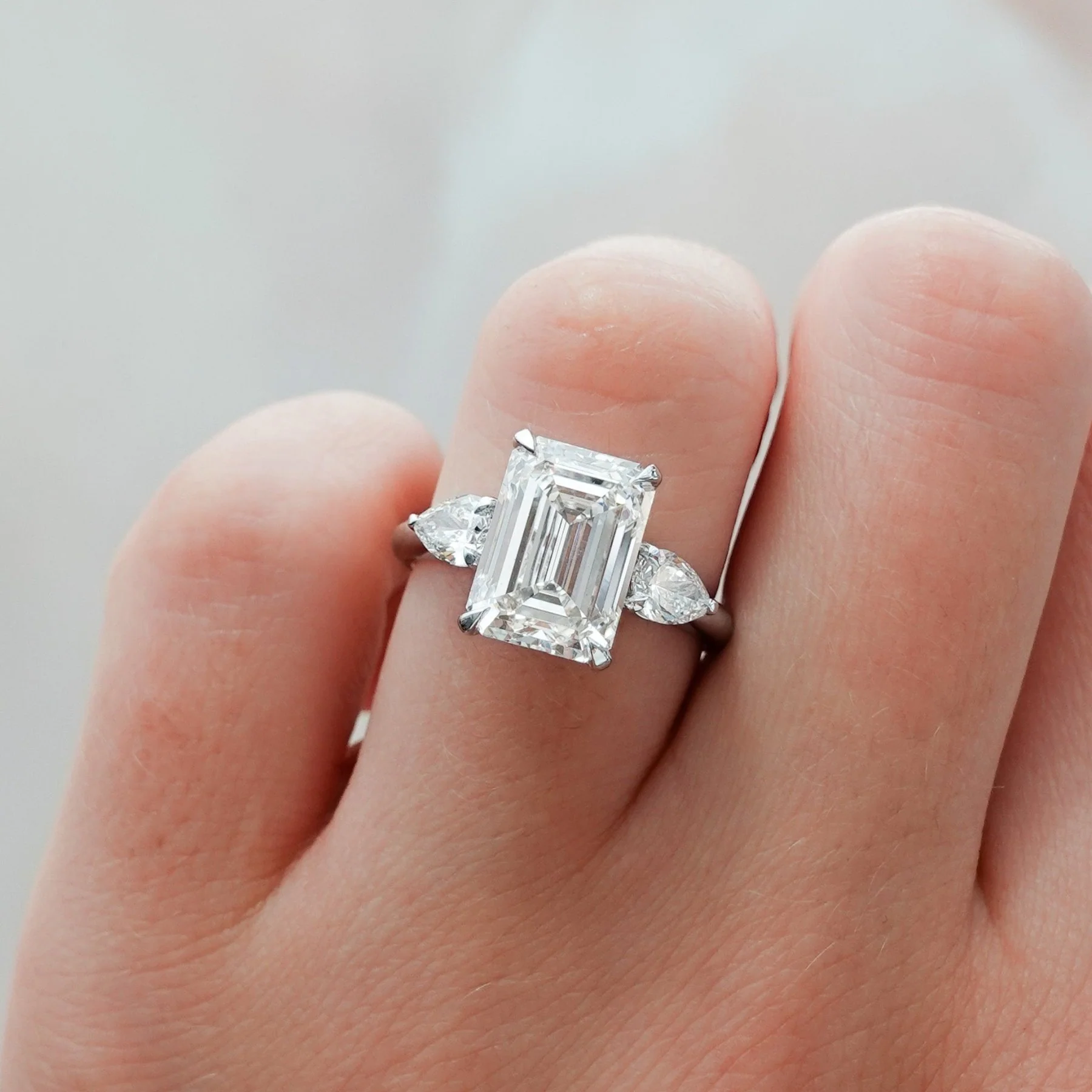 Three Stone Engagement Ring With Pear Side Stones and Emerald Cut Diamond - Image 3