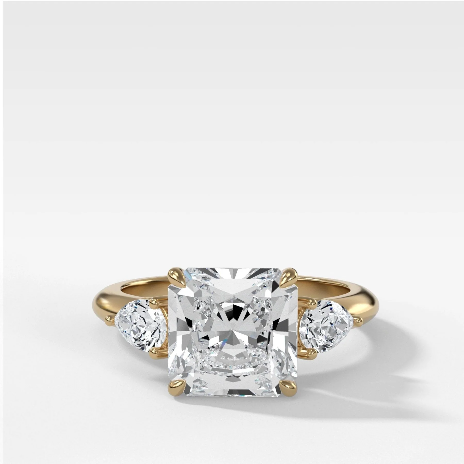 Three Stone Engagement Ring With Pear Side Stones and Radiant Square Cut Diamond