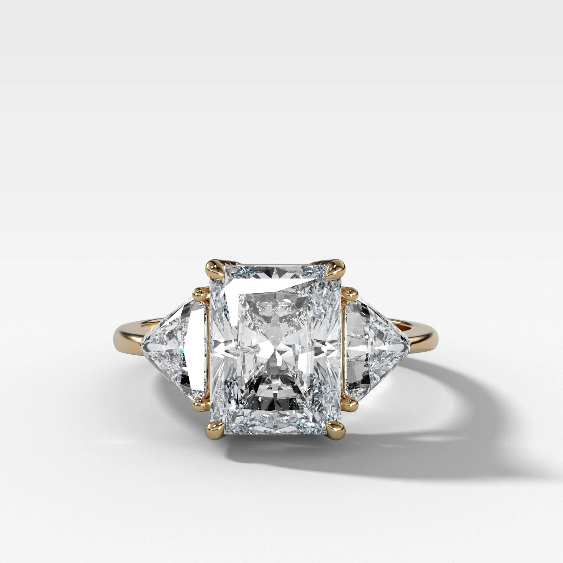 Three Stone Engagement Ring with Shield Side Stones and an Elongated Radiant cut Diamond