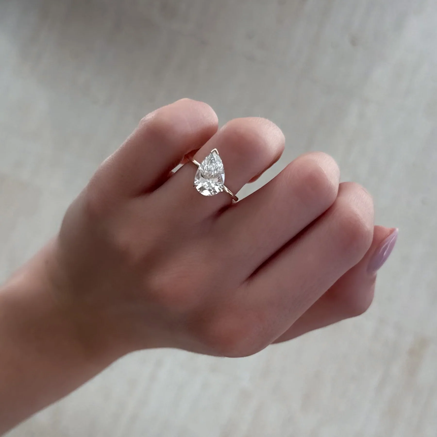 Tilted Thin + Simple Solitaire Engagement Ring With Pear Cut Diamond - Image 3
